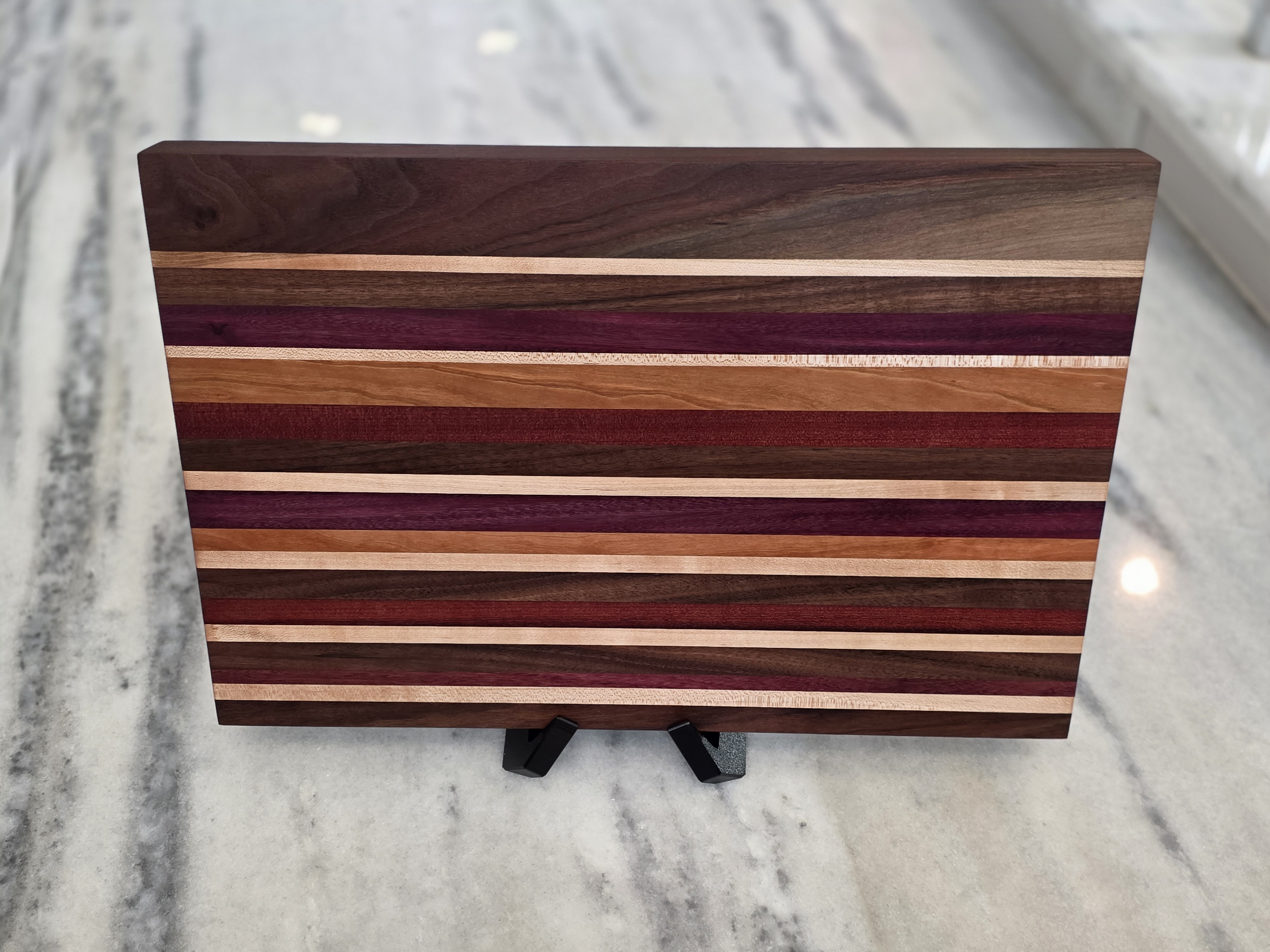 Multi-Species Exotic Striped Edge-Grain Cutting Board on Marble Countertop